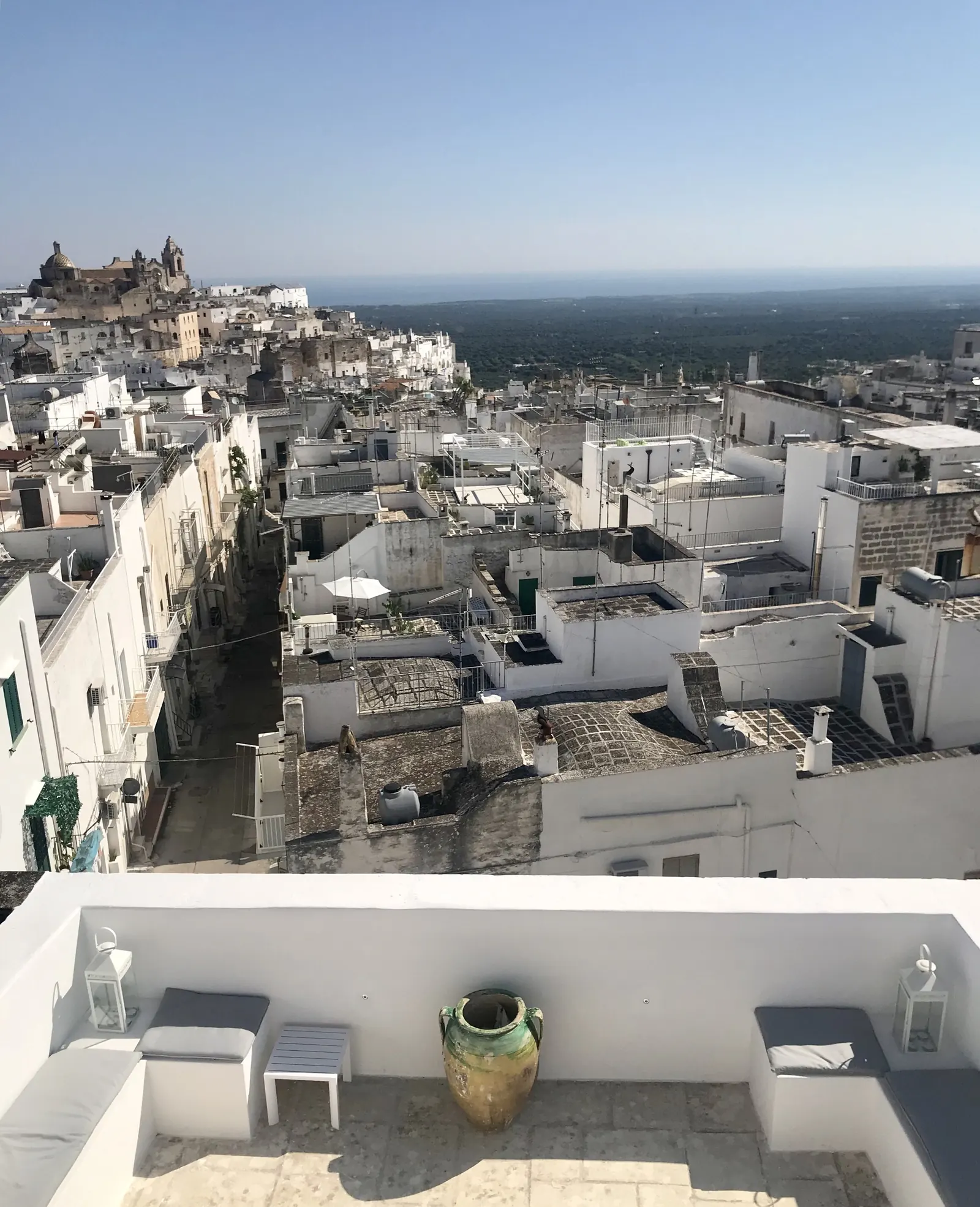 The white rooftops of Ostuni, with the olive groves running to the sea beyond