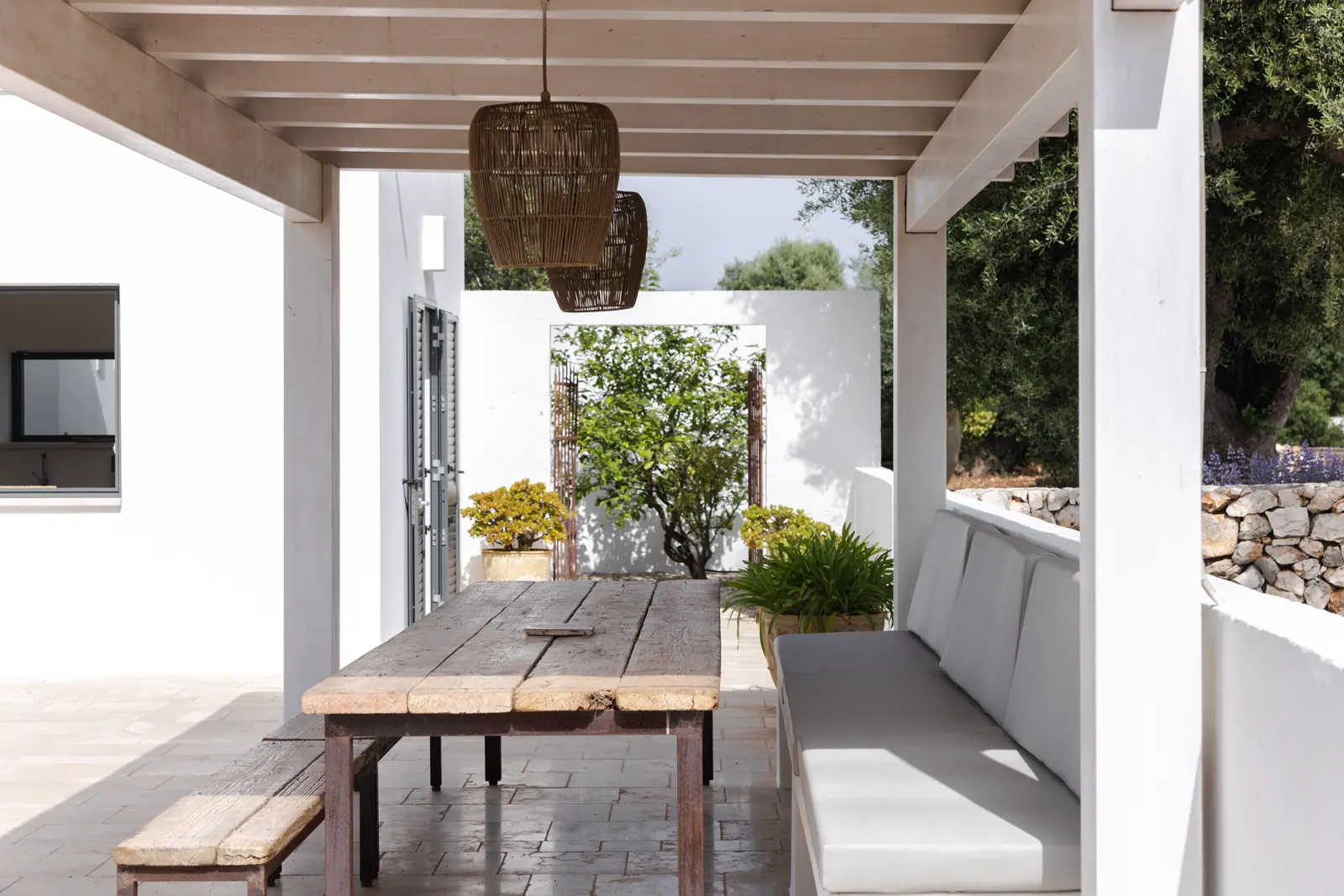 Outdoor dining table for ten under the pergola
