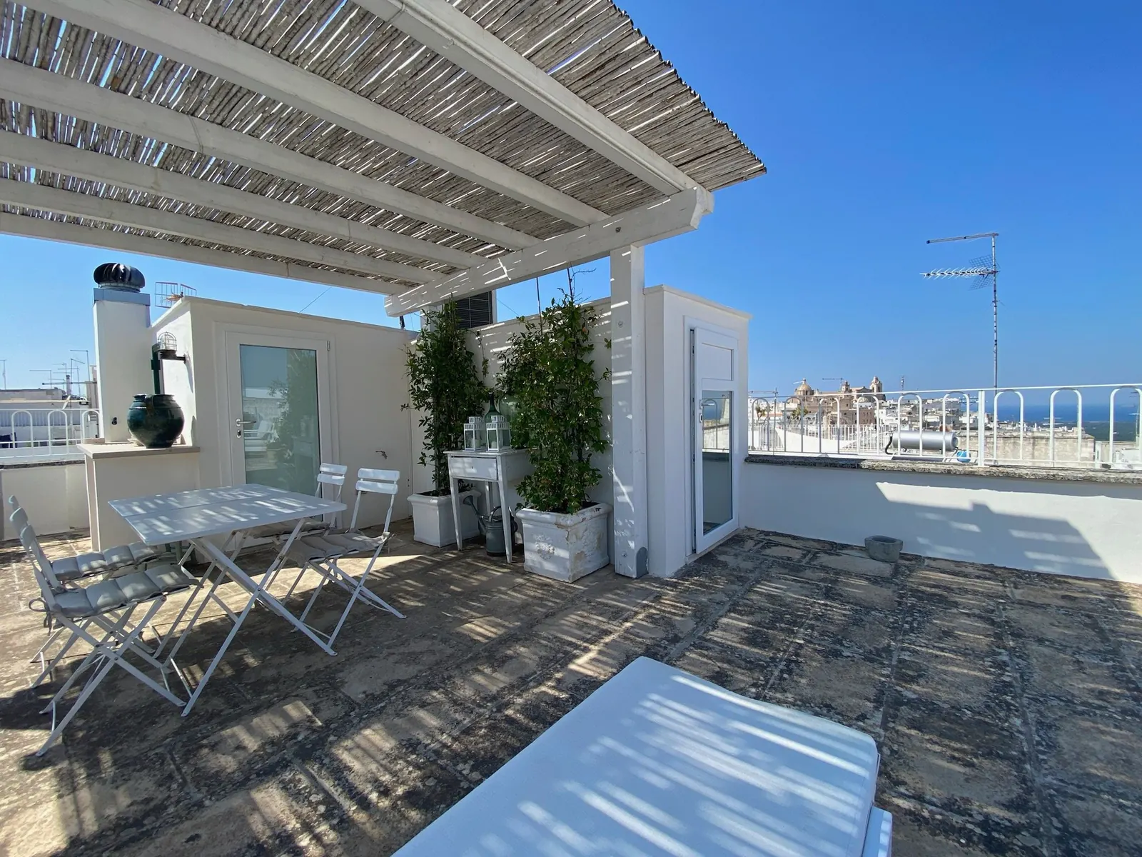 Rooftop terrace under a reed pergola