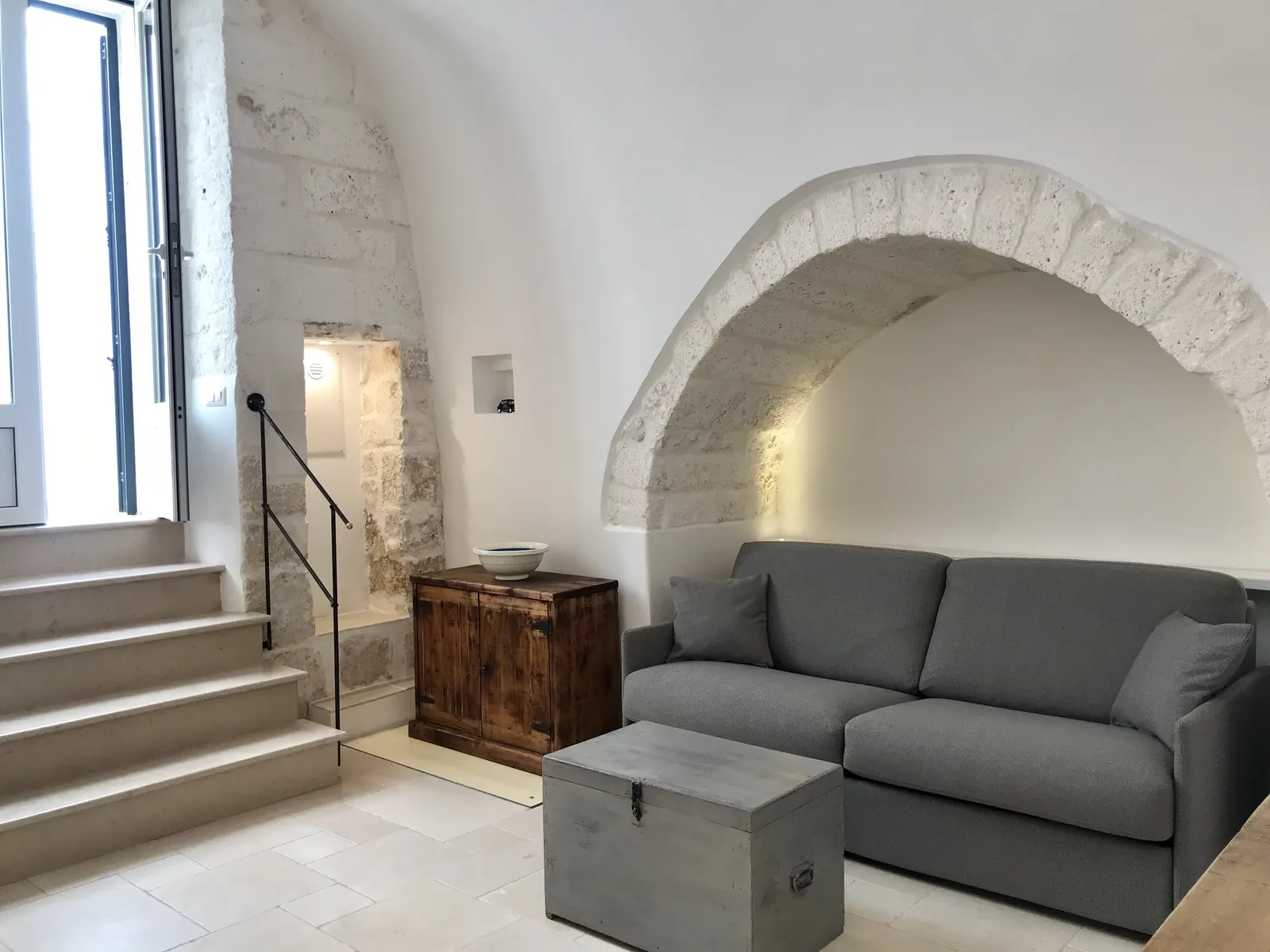 Sofa bed under a stone arch